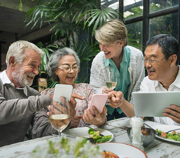Group of Seniors Laughing Over Dinner What is a Reasonable Rate of Return On Retirement Investments Michigan