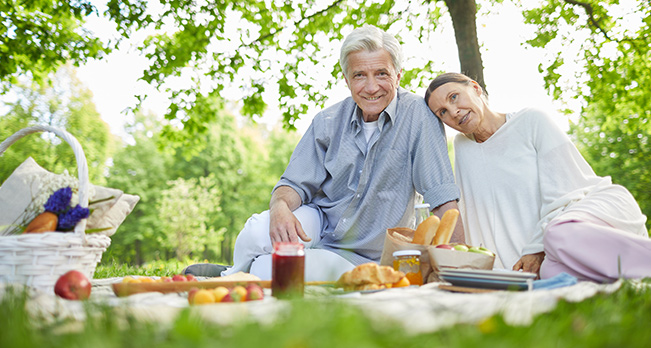 Smiling Senior Couple Having Picnic What is an IUL Policy Michigan