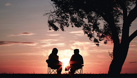 Silhouette of Couple Watching Sunset Guaranteed Basic Income in Retirement Michigan