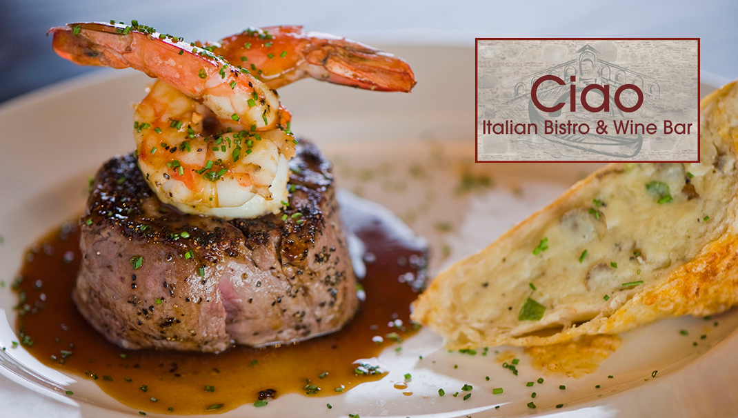 Surf and Turf. Lobster and steak entree. Filet mignon topped with chanterelle mushrooms and Maine lobster tail topped with drawn butter served on white dinner plate. Classic steakhouse menu favorite.