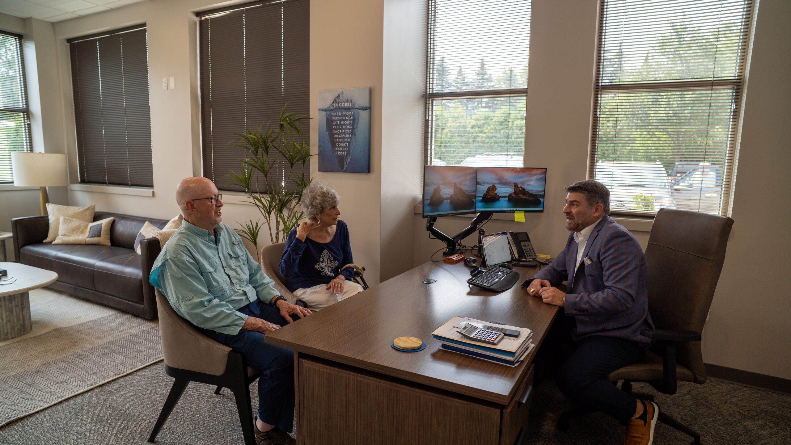 Dan in his office w clients GOOD